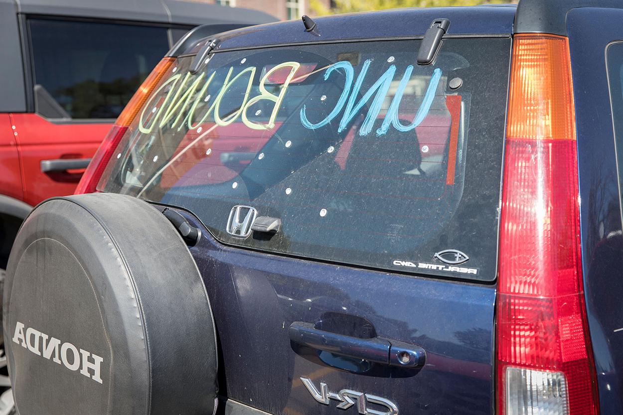 Back car window with the words UNC Bound written on it using paint.